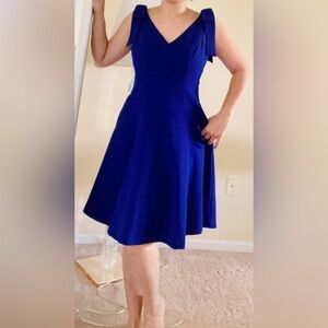 Beautiful blue dress with pockets on sides and large bows on shoulders size 4